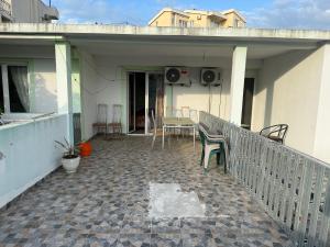 a balcony of a house with a table and chairs at Green Villa in Šušanj