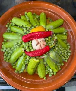 an orange plate of vegetables on a table at Chez Malika in Oulad el Guern