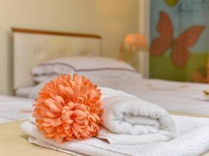 a pile of towels sitting on top of a bed at The Warren Guest House in Carlisle +12 photos