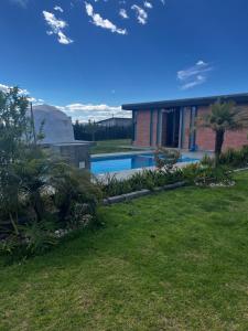 a house with a swimming pool in a yard at Quinta Paco de Lucía in Hacienda Santa Rosa