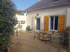 a wooden deck with a table and chairs on a house at Casa del Castel in Dreux