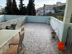 a balcony with two chairs and a table on a balcony at Green Villa in Šušanj