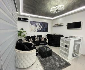 a living room with a couch and a tv at Tina apartman in Vranje