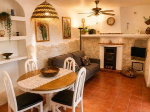 a living room with a table and a couch at Refugio rural en Níjar con jardín privado barbacoa y solarium con vistas únicas in Níjar +33 photos