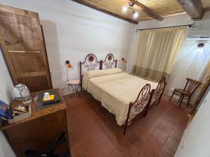 a bedroom with a bed and a table and chairs at B&B Casa Doria in Castelsardo