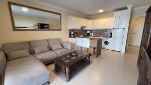 a living room with a couch and a table at Callao Sun & Pool by Diamanteholidays in Callao Salvaje