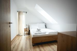a bedroom with a bed with two towels on it at Malé Lipno 1085 in Černá v Pošumaví