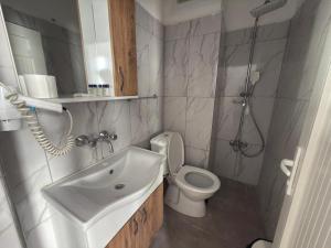 a bathroom with a sink and a toilet and a shower at FİNİKE SEVER OTEL in Finike +136 photos