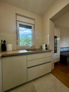 a kitchen with a sink and a window at Apartman Mara in Solin