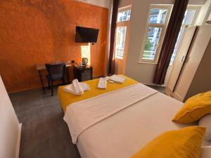 a hotel room with two beds and a table with a chair at FİNİKE SEVER OTEL in Finike