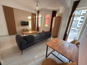 a living room with a couch and a table at FİNİKE SEVER OTEL in Finike