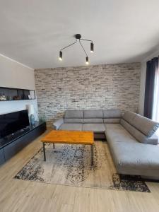 a living room with a couch and a coffee table at Family apartment Cathy in Galižana