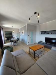 a living room with a couch and a table at Family apartment Cathy in Galižana
