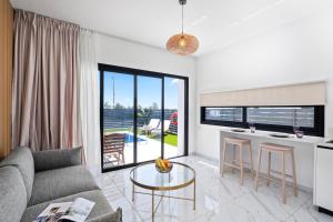 a living room with a couch and a table at Sea Breeze Studios in Pervolia
