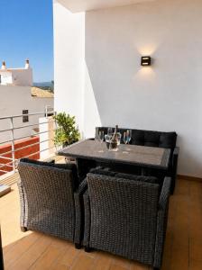 a black table and chairs on a balcony at Vila Rio DOuro in Ferragudo
