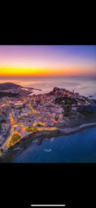 an aerial view of a city at sunset at B&B Casa Doria in Castelsardo