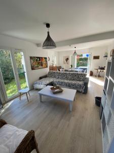 a living room with a couch and a table at tyklan in Bénodet