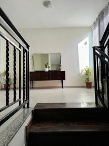 a mirror on the wall in a room with stairs at Villa Emma Durrës in Durrës