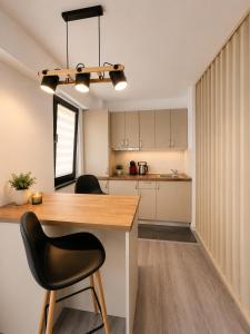 a kitchen with a wooden table and a black chair at Asi Marine Rentals in Saturn