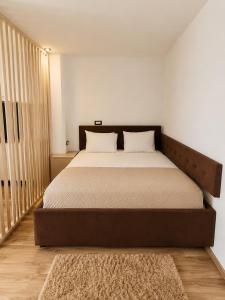 a bedroom with a large bed with a brown headboard at Asi Marine Rentals in Saturn