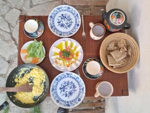a wooden table with plates of food on it at U Kameníků in Lhenice