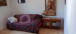 a room with a couch and a table with a mirror at U Kameníků in Lhenice