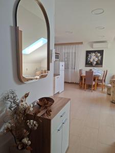 a kitchen and living room with a mirror on the wall at Guest house Lavanda 4 in Njivice