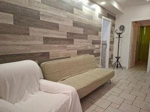 a living room with a couch and a wooden wall at Morrovalle LOVE in Morrovalle