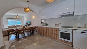 a kitchen with a table and a dining room at Nerina 3 Luxury Villa in Paphos