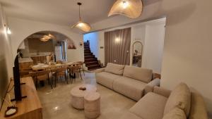 a living room with a couch and a table at Nerina 3 Luxury Villa in Paphos