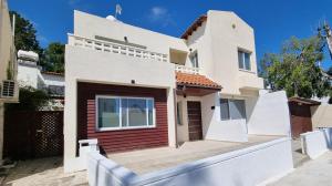 a white house with a fence in front of it at Nerina 3 Luxury Villa in Paphos