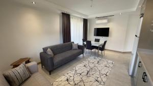 a living room with a couch and a table at Nest Park Side in Side