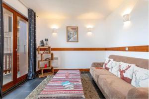 a living room with a couch and a table at Résidence Les Aiguilles de Warens - Combloux in Combloux +163 photos