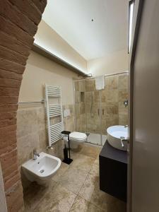a bathroom with a sink and a toilet at Appartamento I 2 Archi in Siena +10 photos