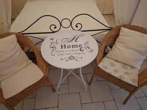 a table with a sign on it with two chairs at Morrovalle LOVE in Morrovalle