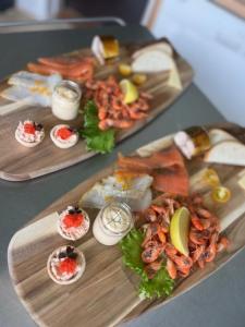 two plates of food with seafood on a table at Langø Fjord Glamping NR 2 in Nakskov