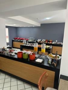 a buffet line with food and drinks in a restaurant at Apart hotel Mercure boa viagem in Recife