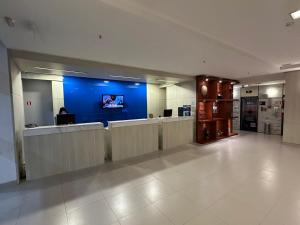 a lobby of a hospital with a blue wall at Apart hotel Mercure boa viagem in Recife +15 photos