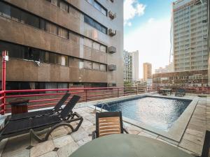a swimming pool on the roof of a building at Apart hotel Mercure boa viagem in Recife