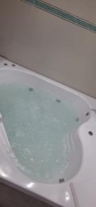 a bath tub filled with water in a bathroom at JAP in Río Gallegos +19 photos