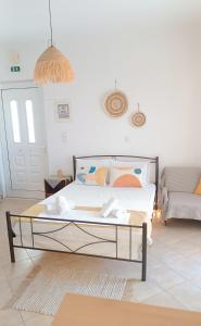 a bed in a living room with a couch at Ammoudeli Coastal Escape in Plomari