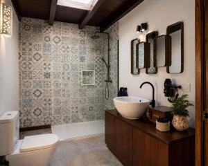 a bathroom with a sink and a toilet and a tub at Villa Blanco - Romantic Hideaway - Private Villa for Couple in Tías +9 photos