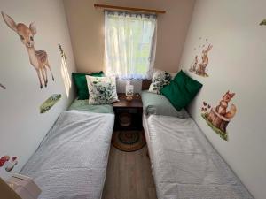 a room with two beds and a table in it at Mobilheim Výr in Výrovice
