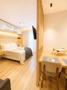 a hotel room with a bed and a table at apartamento vitória 101 in Pomerode +10 photos