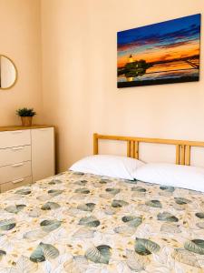 a bedroom with a bed and a painting on the wall at S&S - Marino's Resort in Petrosino +31 photos