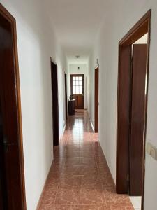 a hallway with white walls and a tile floor at Azul 31 in Lajes das Flores