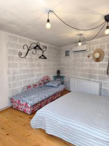 two beds sitting in a room with at Guest house with sauna in Krčedin