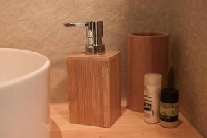 a wooden soap dispenser sitting on top of a sink at Little escape in episkopi-heraklion +29 photos