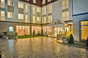 an empty courtyard of a building with a building at Hotel Citrin - Adults Only in Braşov