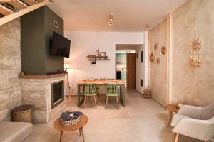 a living room with a table and a fireplace at Little escape in episkopi-heraklion